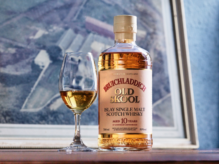 Bottle of whisky next to a glass on a shelf