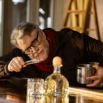 Guillermo del Toro with bottle of Patron Blanco on a bar