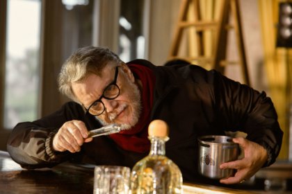 Guillermo del Toro with bottle of Patron Blanco on a bar