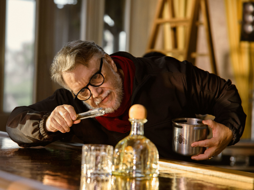 Guillermo del Toro with bottle of Patron Blanco on a bar