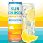A can of Sun Cruiser next to a glass with sunset graphic in background