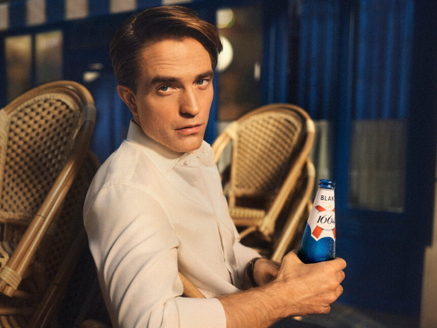 Robert Pattinson with 1664 bottle