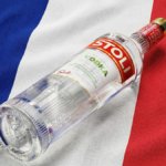 Stoli vodka bottle against French flag