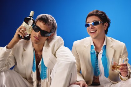 Ca7riel & Paco Amoroso with Ballantine's bottle and glass
