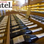 Row of champagne bottles on display in retail environment