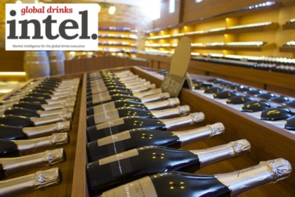 Row of champagne bottles on display in retail environment