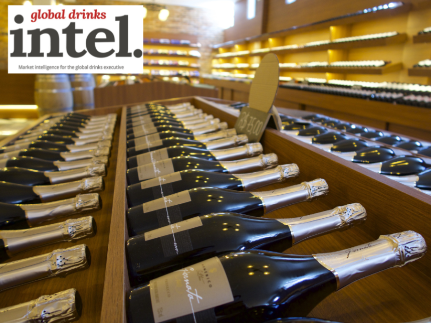 Row of champagne bottles on display in retail environment