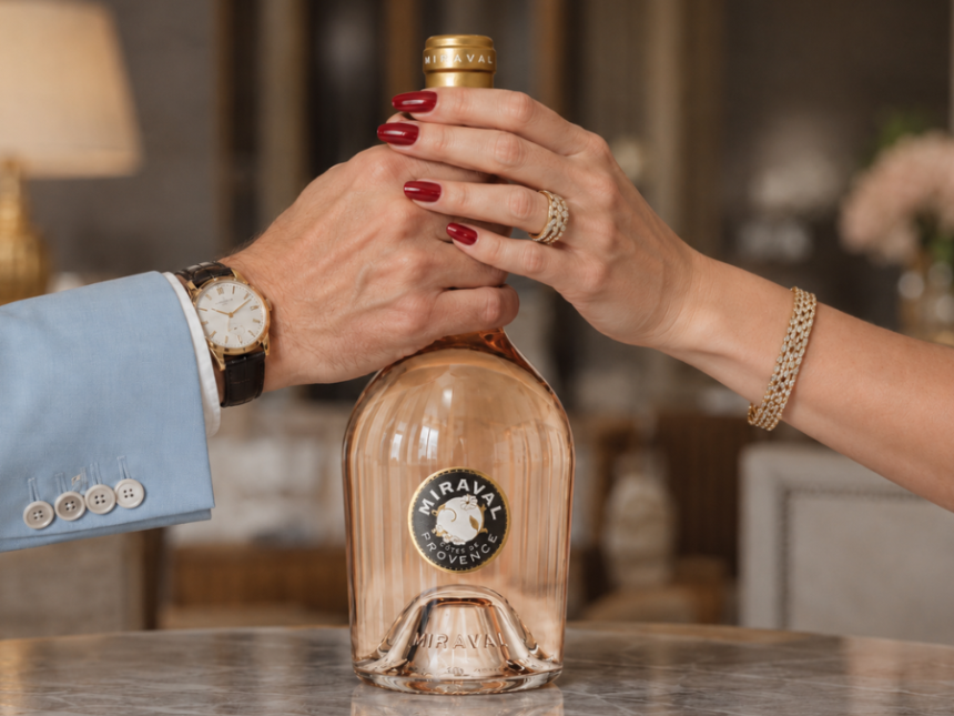 Miraval rose bottle with a male and a female's hands around the neck