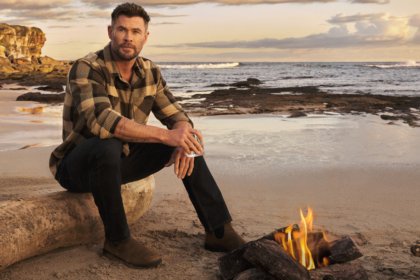 Chris Hemsworth on a beach with a glass of Archie Rose whisky