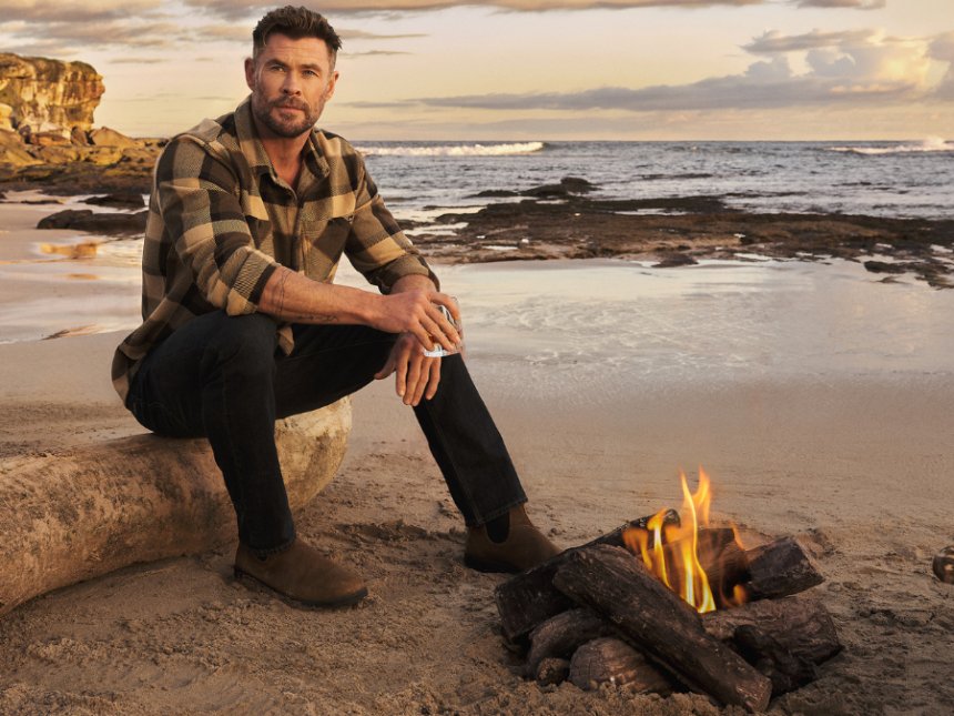 Chris Hemsworth on a beach with a glass of Archie Rose whisky