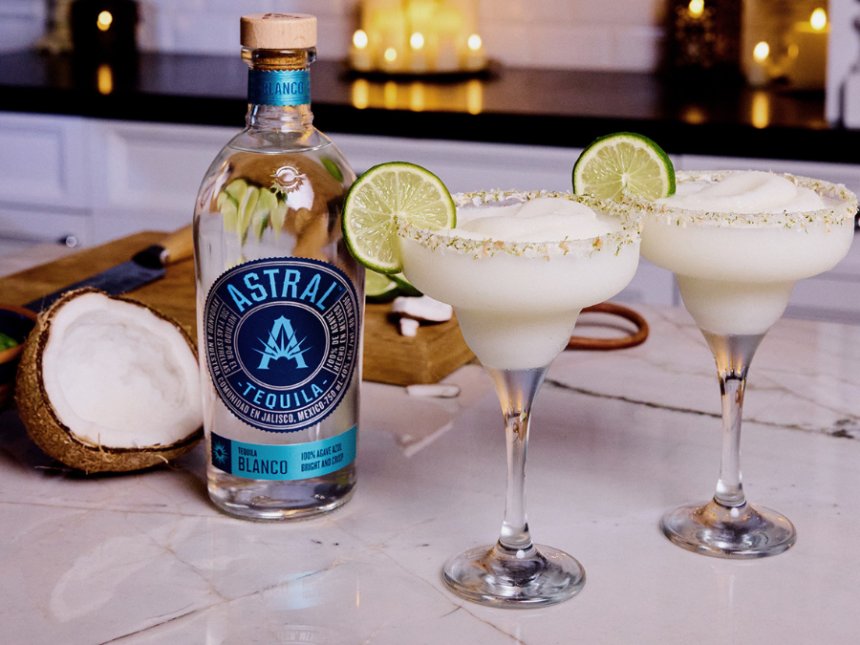 Bottle of Astral Tequila with two margarita serves
