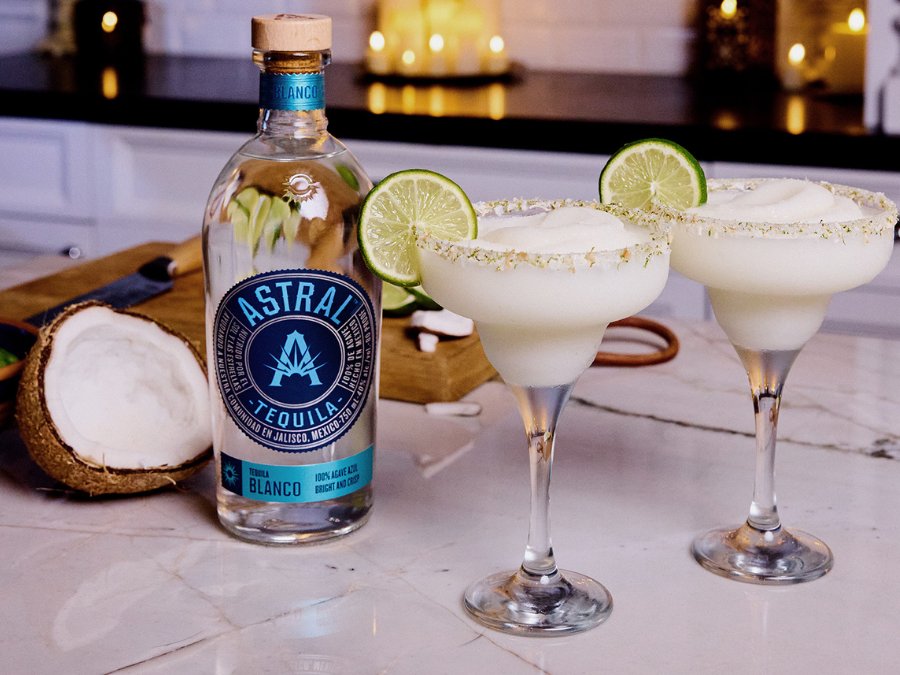 Bottle of Astral Tequila with two margarita serves