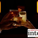Three alcohol-free cocktails raised in a toast in a bar