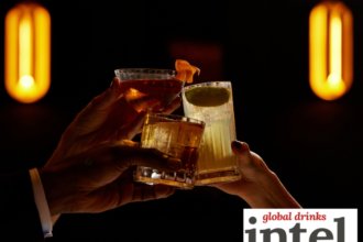 Three alcohol-free cocktails raised in a toast in a bar