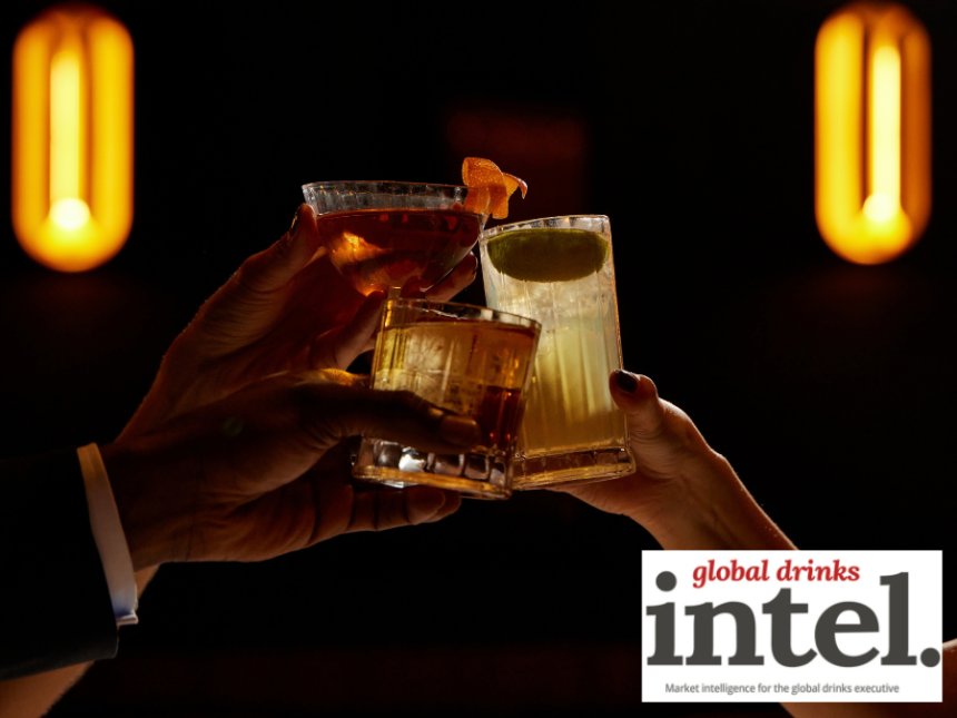 Three alcohol-free cocktails raised in a toast in a bar