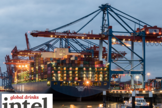 A ship in a port being loaded with containers