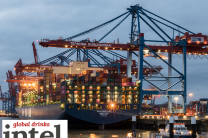 A ship in a port being loaded with containers