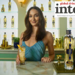 Actor Sophie Turner with St-Germain bottle behind a bar