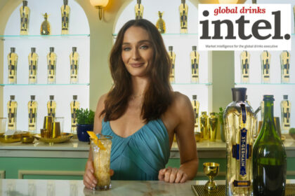 Actor Sophie Turner with St-Germain bottle behind a bar