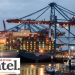 A ship in a port being loaded with containers